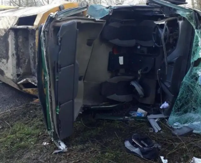 Overturned road-sweeper