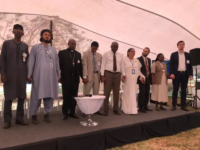 A group gathers for multi-faith prayer