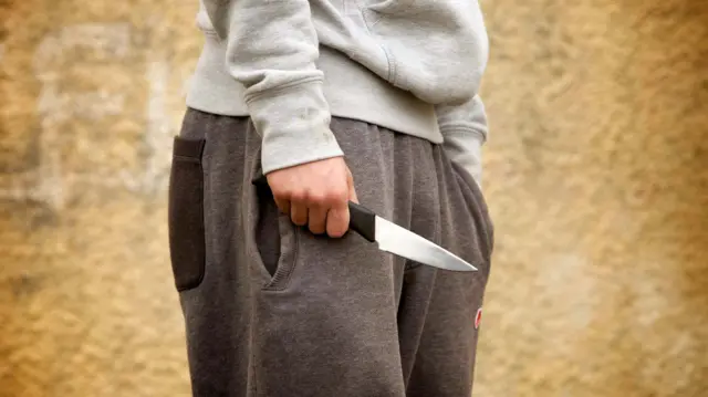 Stock image of person with knife