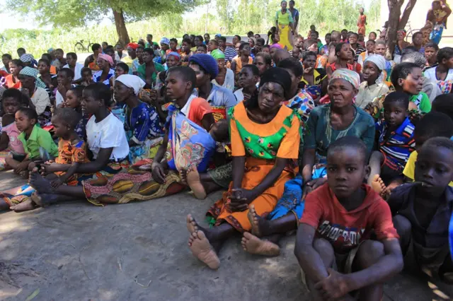 People shelter in a relief camp as their homes have been destroyed