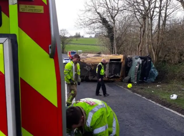 Overturned road-sweeper