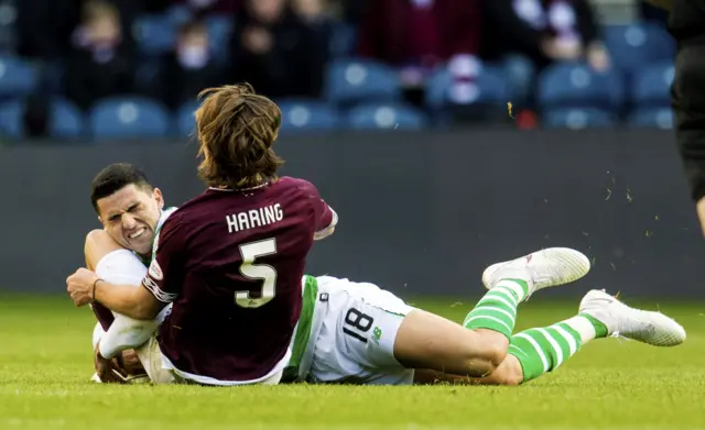 Hearts' Peter Haring and Tom Rogic of Celtic collide