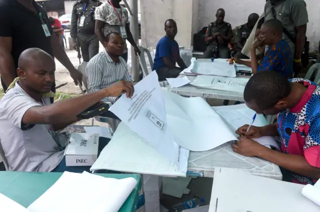 Electoral officials collect results at the state headquarters of the Independent National Electoral Commission (INEC) in Port Harcourt, Rivers State