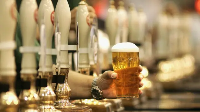 A man serving a pint of beer