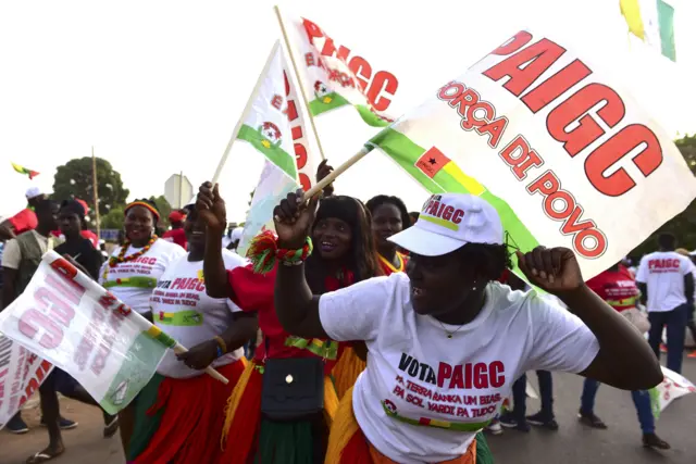 Supporters of the African Party for the Independence of Guinea and Cape Verde (PAIGC) dance as they attend on March 8, 2019 in Bissau