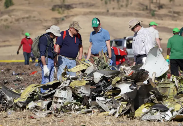 Investigators with the U.S. National Transportation and Safety Board (NTSB) look over debris at the crash site of Ethiopian Airlines Flight ET 302 on March 12, 2019 in Bishoftu, Ethiopia.