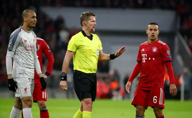 Referee Daniele Orsato gestures to both sets of players