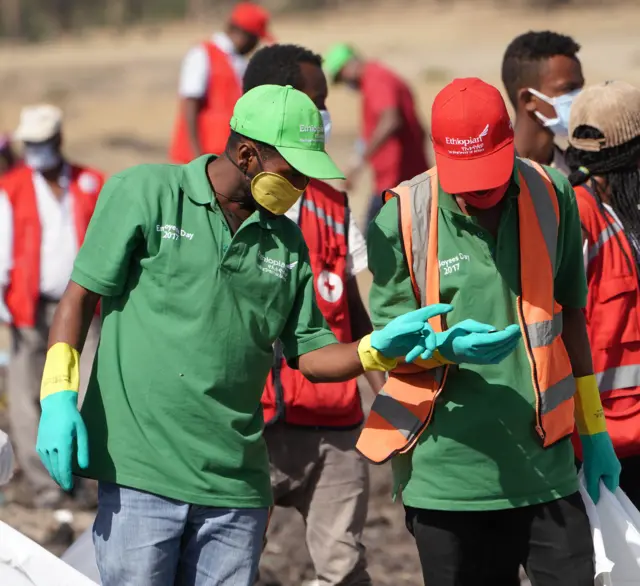 Forensics investigators and recovery teams collect personal effects and other materials from the crash site of Ethiopian Airlines Flight ET 302 on March 12, 2019 in Bishoftu, Ethiopia.