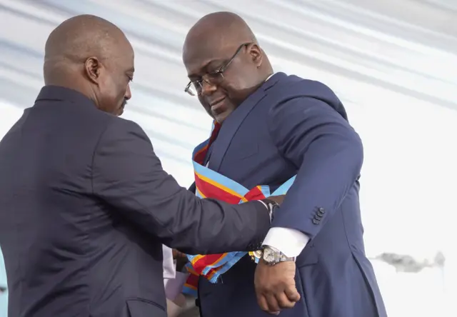 Felix Tshisekedi receives the presidential sash from the outgoing President Joseph Kabila