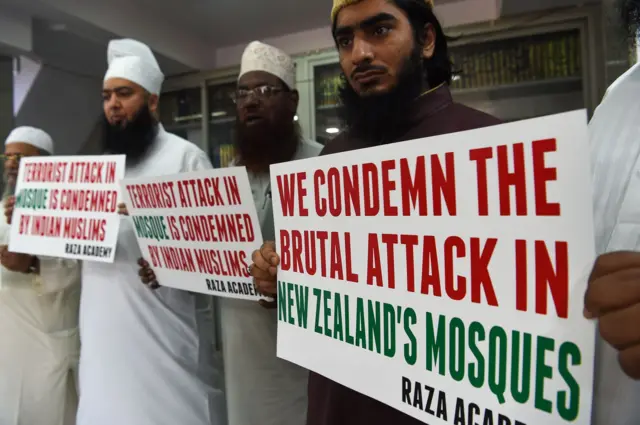 Protesters in Mumbai holding posters condemning the attack