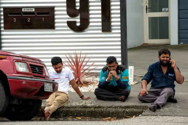 People sit outside Al Noor mosque