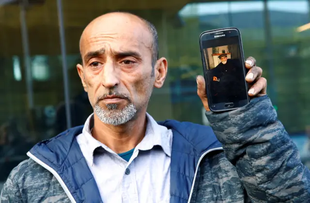 omar nabi with photo of father daoud nabi