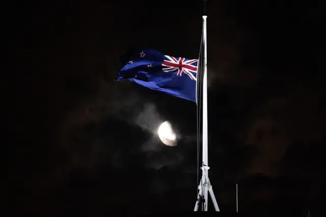 The New Zealand national flag is flown at half-mast on a Parliament building in Wellington