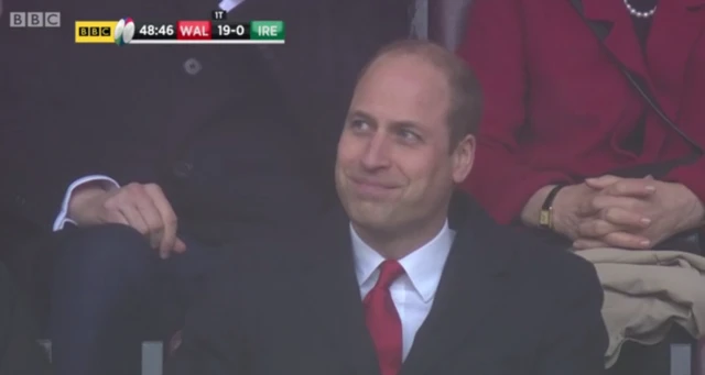 Prince William smiling in the crowd