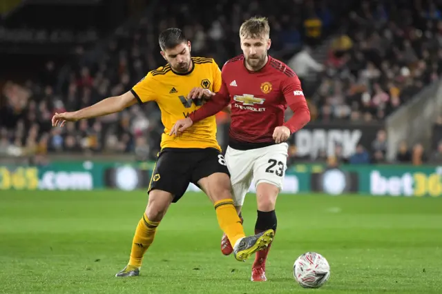 Ruben Neves of Wolverhampton Wanderers and Luke Shaw of Manchester United