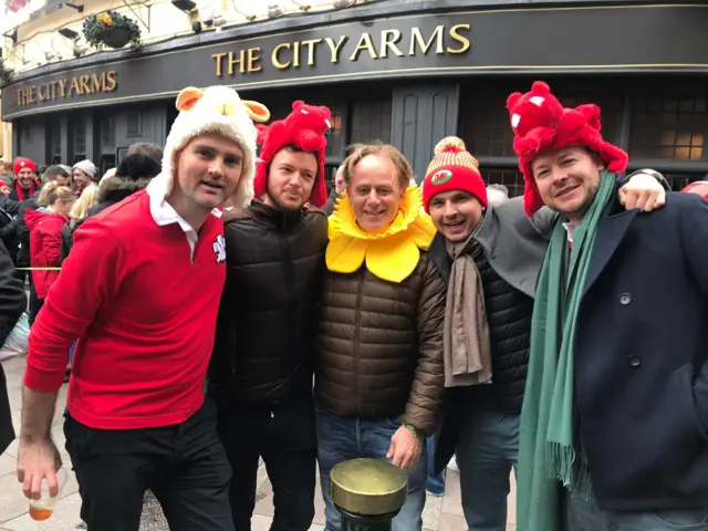 A group of four men with dragon and daffodil hats