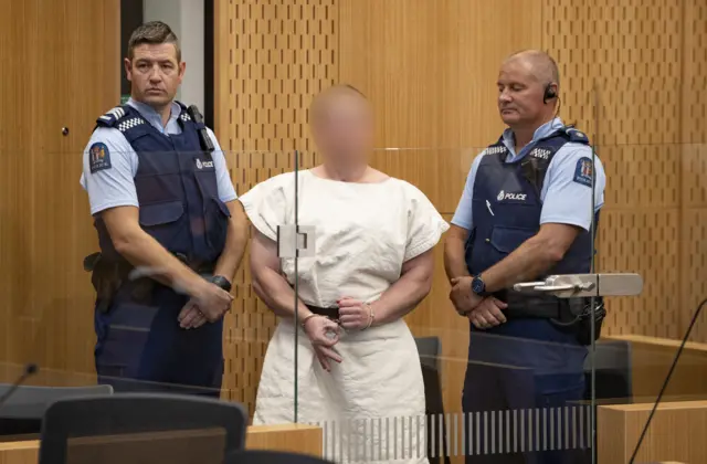 Brenton Tarrant flashes 'white power symbol' in court