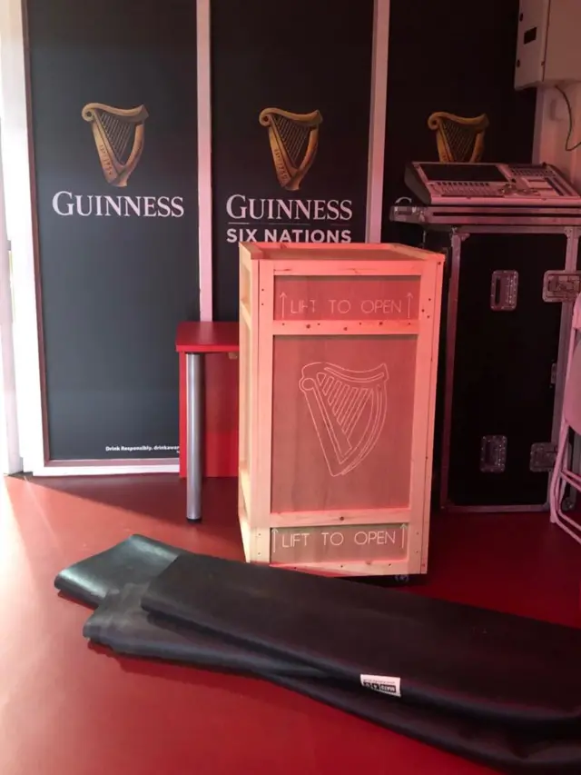 A wooden box with the Guinness emblem on it