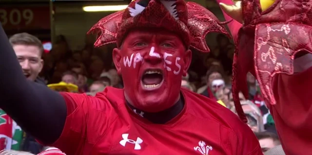 A Wales fan with face paint saying Wales