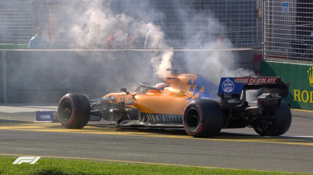 Carlos Sainz McLaren with smoke coming out the back