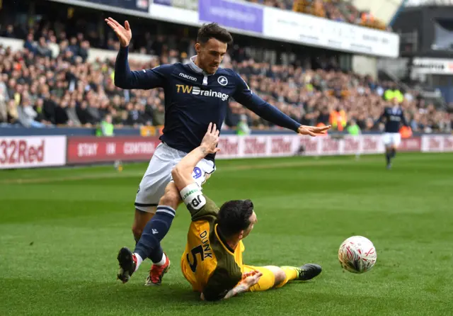 Lee Gregory of Millwall clashes with Lewis Dunk