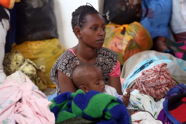 An Ethiopian woman holds a baby at a temporary refuge center in Burayu of Oromia Region, Ethiopia on September 18, 2018.