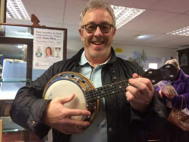 Anthony Mason with his recently-purchased Dallas D ukulele-banjo