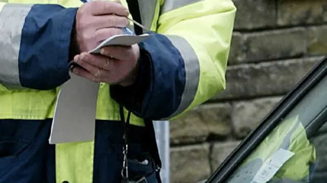 Traffic warden giving ticket