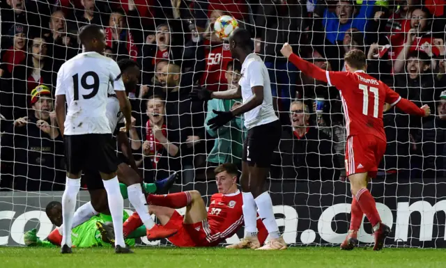 Wales' Ben Woodburn scores their first goal