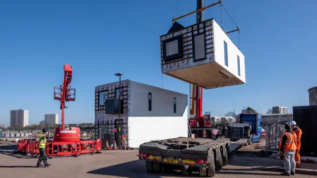 First homes being craned into position