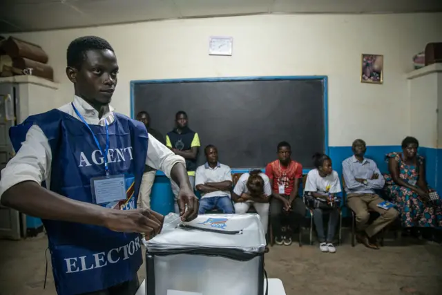 An Independent National Electoral Commission (CENI) agent seals a ballot box