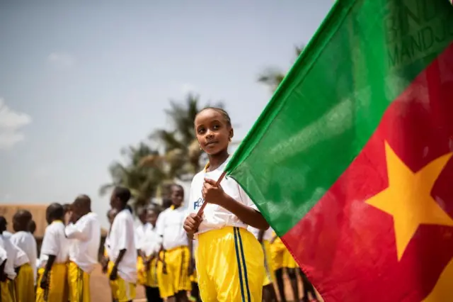 Children in Cameroon's capital, Yaoundé, wait to meet football star Samuel Eto'o on Monday at an event organised by Fifa.