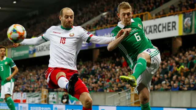 Northern Ireland"s George Saville in action with Belarus" Ivan Maevski