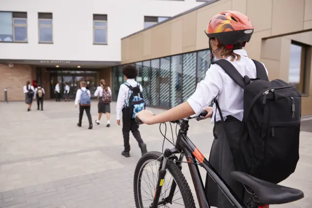 Child with bike at school