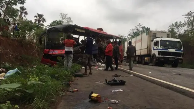 A destroyed bus seen by the roadside after crashing into another vehicle