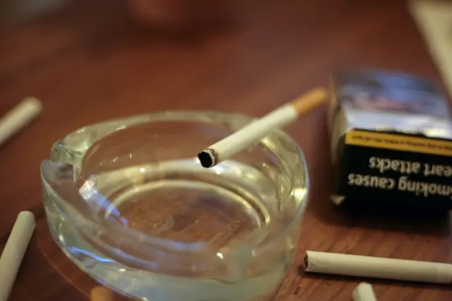 A cigarette lying in an ashtray