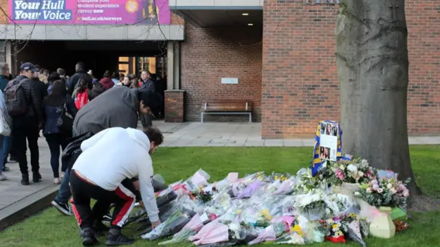 Students lay flowers at the University of Hull