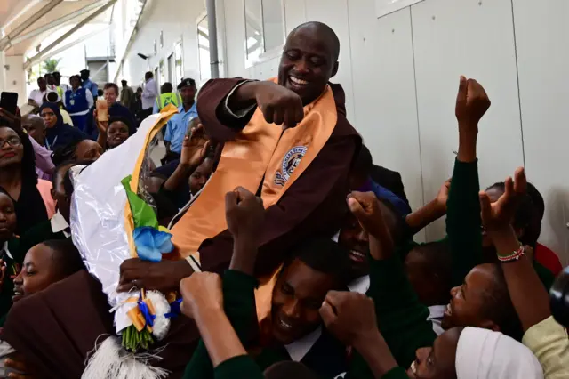 Peter Tabichi being welcomed by students