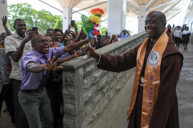 Peter Tabichi being welcomed by students