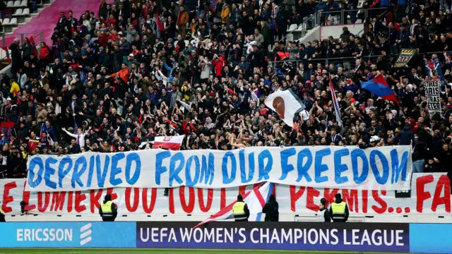 PSG fans hold up a banner saying 'Deprived from our freedom'