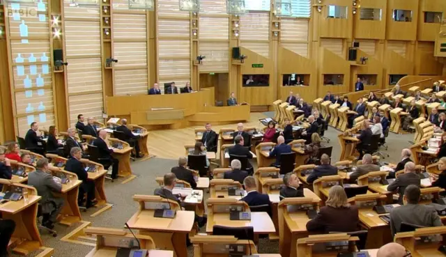 MSPs looking up at the distraction