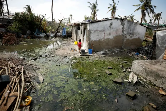 A child stands amongst pools of stagnant water in Beira, Mozambique, March 27, 2019