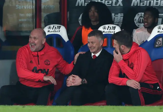 Mike Phelan and Michael Carrick sit either side of Ole Gunnar Solskjaer