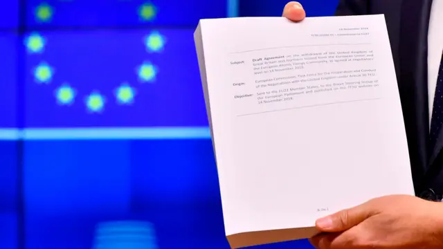 Donald Tusk holds the draft Brexit withdrawal agreement