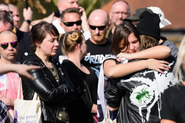 Prodigy fans hug at Keith Flint's funeral.