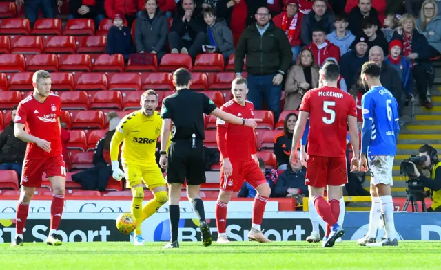 Referee Kevin Clancy points to the spot after Rangers' Connor Goldson fouls Aberdeen's Gary Mackay-Steven