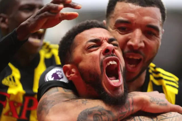 Andre Gray of Watford celberates after scoring his sides second goal during the Premier League match between Watford FC and Leicester City