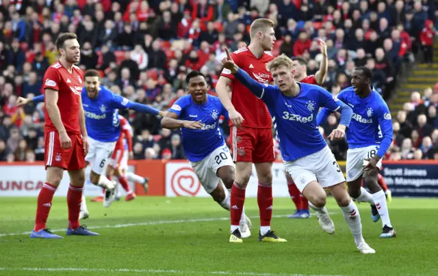 Joe Worrall wheels away in celebration after equalising for Rangers