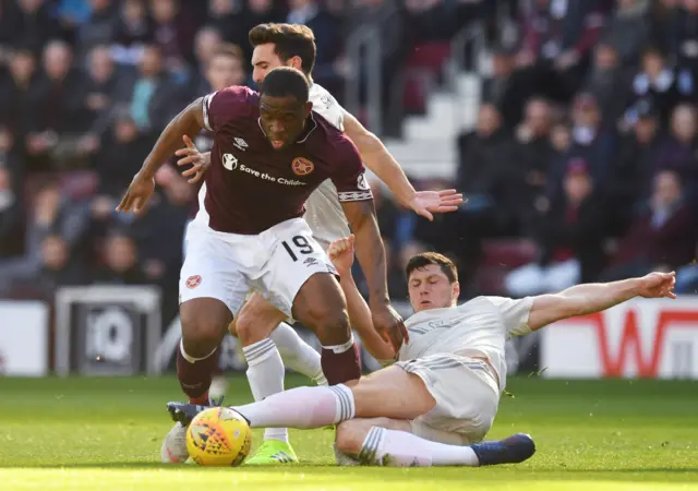 Hearts’ Uche Ikpeazu drives away from Aberdeen’s Scott McKenna