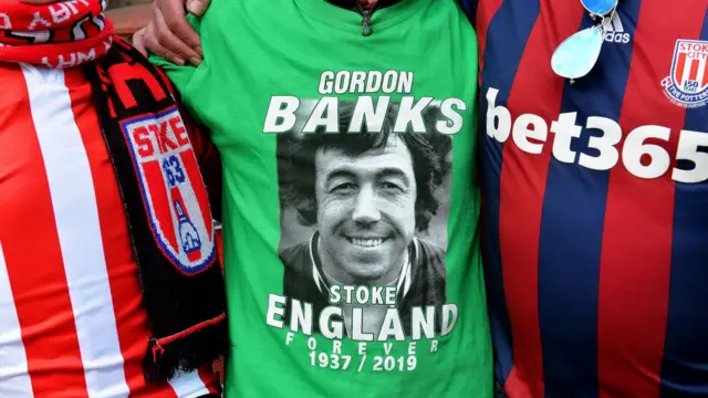 Football fans, one wearing a commemorative Gordon Banks shirt (c)